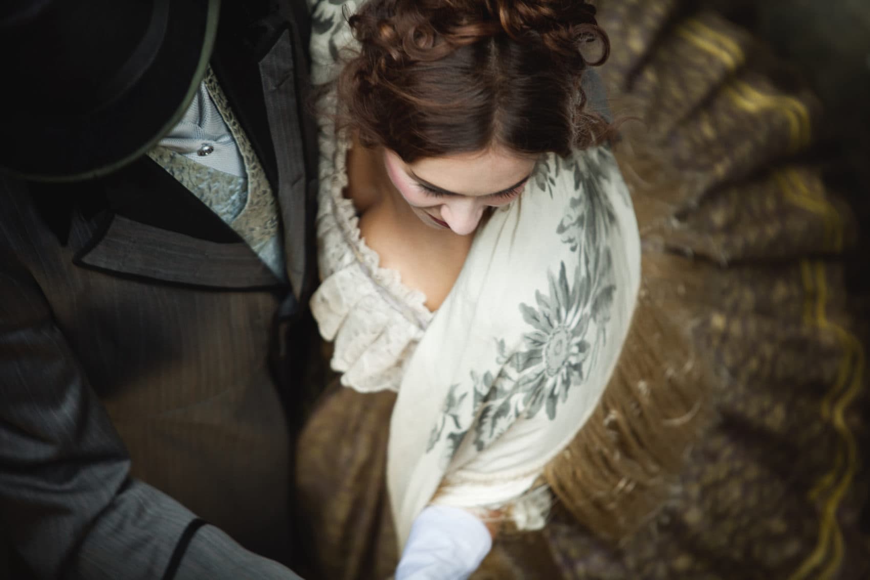 Aerial view of a couple in vintage attire, showcasing elegant details of their clothing. Aerial view of a couple in vintage attire, showcasing elegant details of their clothing.