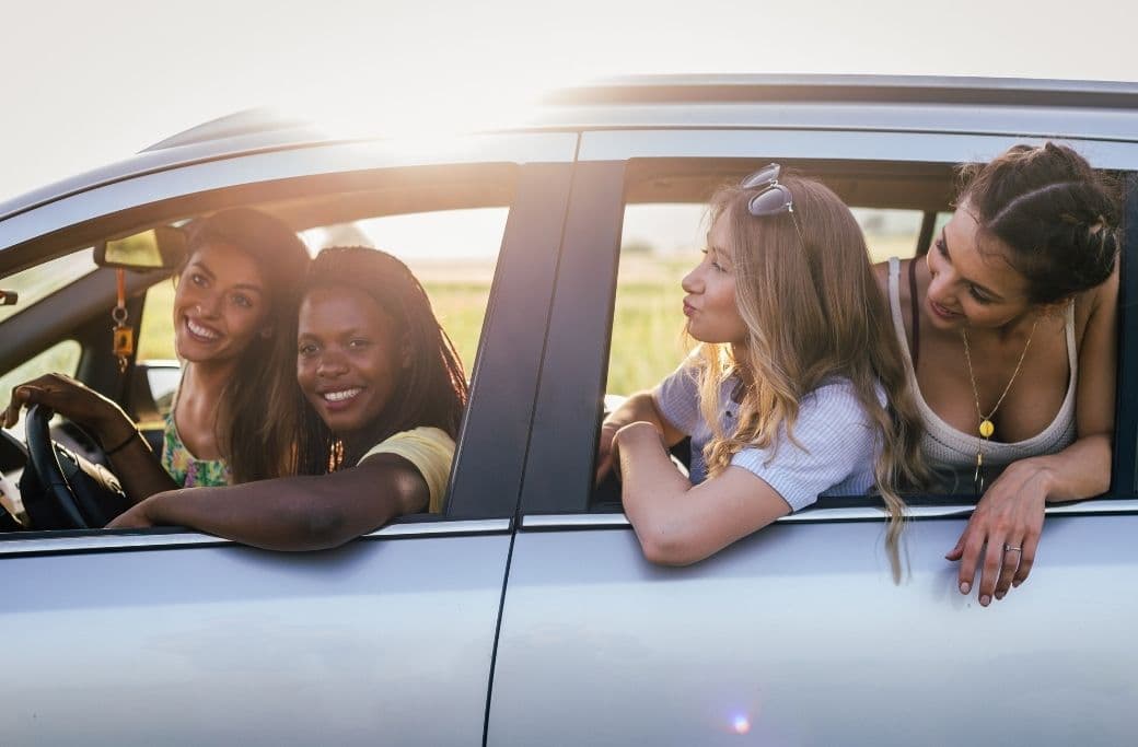 Four women enjoying a joyful moment together in a car. Four women enjoying a joyful moment together in a car.
